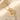 Rotatable clover pendant close-up on cream satin