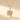 Gold-tone rotatable clover pendant on a beige background