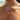 Man wearing a silver-tone cross pendant rope chain necklace outdoors by the sea