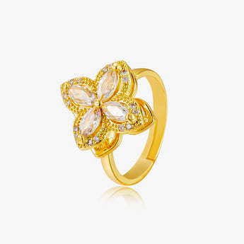 Gold-tone rotatable four-leaf clover ring with clear stones on a light grey background