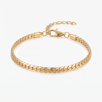 Gold flat chain bracelet with lobster clasp and extender chain on a white background