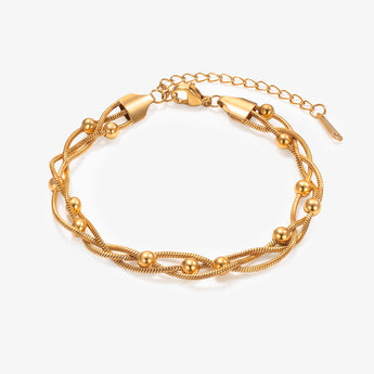 Gold-tone layered bead chain bracelet with extension chain on white background