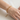 Gold-tone layered bead chain bracelet worn on wrist
