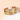 Gold-tone multilayer strand bracelet with clasp resting on a white pedestal