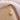 gold-tone sunflower zirconia pendant necklace on a beige jewelry box with sheer fabric