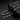 Silver-tone rhombus link chain with lobster clasp on dark background
