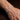 Close-up of a man's wrist wearing a silver-tone tennis bracelet with cubic zirconia