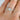 Gold-tone square zirconia cluster ring worn on a finger, close-up