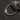 Custom engraved Cuban chain bracelet resting on a rock on dark surface