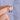 Finger wearing stacked silver-tone and gold-tone engraved open wrap rings