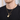 Man wearing a gold-tone guitar pendant necklace on a box chain