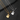 Gold-tone guitar pendant necklace engraved with Forever and silver-tone one engraved with Love You on dark slate