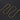 Gold-tone snake chain necklace with lobster clasp laid out on a dark background