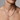 Man wearing silver-tone rhombus link chain necklace, front view