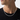 Man in black T-shirt wearing silver-tone rhombus link chain necklace