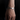 Silver-tone zodiac charm bracelet worn on a wrist against a dark background